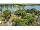 Beautiful lakefront property features lush greenery surrounding a cozy home, captured in this appealing aerial view at 2990 E Central Ave, Bartow, FL 33830
