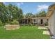 Large backyard view showcasing a home with a screened-in porch and plenty of space for recreation at 2990 E Central Ave, Bartow, FL 33830