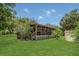 Lush green backyard showcasing a charming screened-in porch perfect for relaxing outdoors at 2990 E Central Ave, Bartow, FL 33830