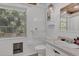 Bright bathroom with a white sink, toilet, and window providing natural light, showcasing a clean and functional space at 2990 E Central Ave, Bartow, FL 33830