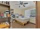 Bedroom featuring a queen-sized bed, ceiling fan, and shelves filled with books and other items, creating a cozy space at 2990 E Central Ave, Bartow, FL 33830