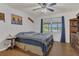 Bedroom with a comfortable bed, dark blue curtains, and a view of a lake through the window at 2990 E Central Ave, Bartow, FL 33830