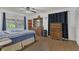 Cozy bedroom featuring wooden dresser, ceiling fan, and a window offering natural light and a view of the outdoors at 2990 E Central Ave, Bartow, FL 33830
