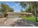 A charming ranch-style home showcasing a two-car garage and a spacious driveway at 2990 E Central Ave, Bartow, FL 33830