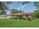 Landscaped front yard of ranch-style home with a well-maintained lawn at 2990 E Central Ave, Bartow, FL 33830
