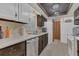 Functional kitchen with dark cabinets, laminate countertops, and white appliances at 2990 E Central Ave, Bartow, FL 33830