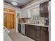 Functional kitchen with dark cabinets, laminate countertops, stainless dishwasher and white appliances at 2990 E Central Ave, Bartow, FL 33830