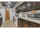 Functional kitchen with dark cabinets, laminate countertops, and white appliances at 2990 E Central Ave, Bartow, FL 33830