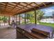 Relaxing covered patio with a spa, offering serene views of the backyard at 2990 E Central Ave, Bartow, FL 33830