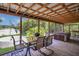 Relaxing covered patio with a dining table, offering serene views of the backyard at 2990 E Central Ave, Bartow, FL 33830