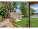 Backyard shed for outdoor storage near lake with mature trees at 2990 E Central Ave, Bartow, FL 33830