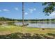 Beautiful waterfront property with a wooden dock and green lawn leading to the lake at 2990 E Central Ave, Bartow, FL 33830