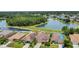 Aerial view of homes with tranquil lake views, surrounded by mature trees in a peaceful neighborhood at 3009 Park Ridge Ave, Mulberry, FL 33860