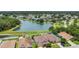 Aerial view of the homes featuring a serene lake, lush landscaping, and well-maintained properties at 3009 Park Ridge Ave, Mulberry, FL 33860