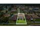 Aerial view of the backyard showcasing a sparkling swimming pool, lush lawn, and privacy fence at 3009 Park Ridge Ave, Mulberry, FL 33860