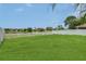 Well-maintained backyard featuring lush green lawn and pond at 3009 Park Ridge Ave, Mulberry, FL 33860
