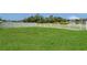 Green backyard enclosed by a white picket fence, offering a secure and private outdoor space at 3009 Park Ridge Ave, Mulberry, FL 33860