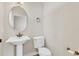 Powder room with pedestal sink, decorative mirror, and tiled floor at 3009 Park Ridge Ave, Mulberry, FL 33860