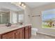 Bathroom with double sink vanity, decorative fixtures, and tiled flooring at 3009 Park Ridge Ave, Mulberry, FL 33860