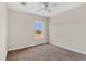 Neutral bedroom with carpet, ceiling fan and a window overlooking the front yard at 3009 Park Ridge Ave, Mulberry, FL 33860