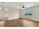 Bedroom featuring wood floors, a ceiling fan and a view of the landscape at 3009 Park Ridge Ave, Mulberry, FL 33860