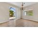 Bright dining room with tile floors, chandelier, and sliding glass doors to the backyard at 3009 Park Ridge Ave, Mulberry, FL 33860
