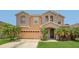 Charming two-story home with a two car garage, lush landscaping, and inviting front entrance at 3009 Park Ridge Ave, Mulberry, FL 33860