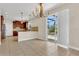View of open kitchen, dining area and sliding glass doors leading to a screened pool at 3009 Park Ridge Ave, Mulberry, FL 33860