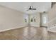 Inviting living room featuring tile floors, natural light, and modern ceiling fan at 3009 Park Ridge Ave, Mulberry, FL 33860
