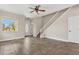 Bright living room featuring tile floors and stairs, with a front door leading to the outside at 3009 Park Ridge Ave, Mulberry, FL 33860