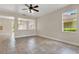 Spacious living room with tile floors and natural light, flowing into the dining area at 3009 Park Ridge Ave, Mulberry, FL 33860