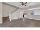 Open living room featuring tile floors and staircase, seamlessly connecting to the kitchen at 3009 Park Ridge Ave, Mulberry, FL 33860