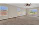 Main bedroom with carpet, ceiling fan, trey ceiling and natural light from windows at 3009 Park Ridge Ave, Mulberry, FL 33860