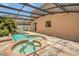 Outdoor pool and spa area with screened enclosure at 3009 Park Ridge Ave, Mulberry, FL 33860