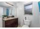 Bathroom featuring a granite countertop vanity, window, toilet, and mirror at 3280 Pinto Dr, Kissimmee, FL 34746