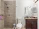 Bathroom featuring a tiled walk-in shower, granite countertop vanity, and toilet at 3280 Pinto Dr, Kissimmee, FL 34746