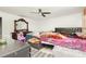 Bedroom with ceiling fan, dresser with mirror, and ample natural light at 3280 Pinto Dr, Kissimmee, FL 34746