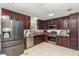 Well-equipped kitchen with stainless steel appliances, dark cabinets, and granite countertops at 3280 Pinto Dr, Kissimmee, FL 34746
