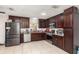 Well-equipped kitchen with stainless steel appliances, dark cabinets, and granite countertops at 3280 Pinto Dr, Kissimmee, FL 34746