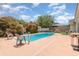Backyard pool featuring mature landscaping, picnic tables, and patio space at 3280 Pinto Dr, Kissimmee, FL 34746