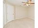 An empty bedroom with carpet, ceiling fan and a large closet at 33042 Lake Bend Cir, Leesburg, FL 34788