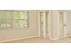 Bedroom featuring window views and access to the patio at 33042 Lake Bend Cir, Leesburg, FL 34788