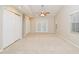 Large bedroom featuring carpet, ceiling fan, and double doors to outside at 33042 Lake Bend Cir, Leesburg, FL 34788