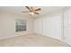 Bedroom featuring ceiling fan, closet and a window that provides natural light at 33042 Lake Bend Cir, Leesburg, FL 34788