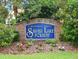 Entrance to Silver Lake Forest, a deed restricted community, is marked by this elegant brick sign, surrounded by lush landscaping at 33042 Lake Bend Cir, Leesburg, FL 34788