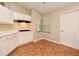 Kitchen with stainless appliances, white cabinets, and tile flooring for easy cleanup at 33042 Lake Bend Cir, Leesburg, FL 34788