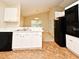 White cabinets with modern appliances, including a black refrigerator and oven at 33042 Lake Bend Cir, Leesburg, FL 34788