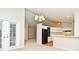 Living room with vaulted ceilings adjacent to kitchen with modern appliances and a breakfast bar at 33042 Lake Bend Cir, Leesburg, FL 34788