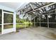 Screened-in back patio with a view of lush greenery and a shaded yard at 33042 Lake Bend Cir, Leesburg, FL 34788