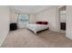 Bedroom with beige carpet, mini fridge, queen bed, and window at 3508 Brighton Park Cir, Belle Isle, FL 32812